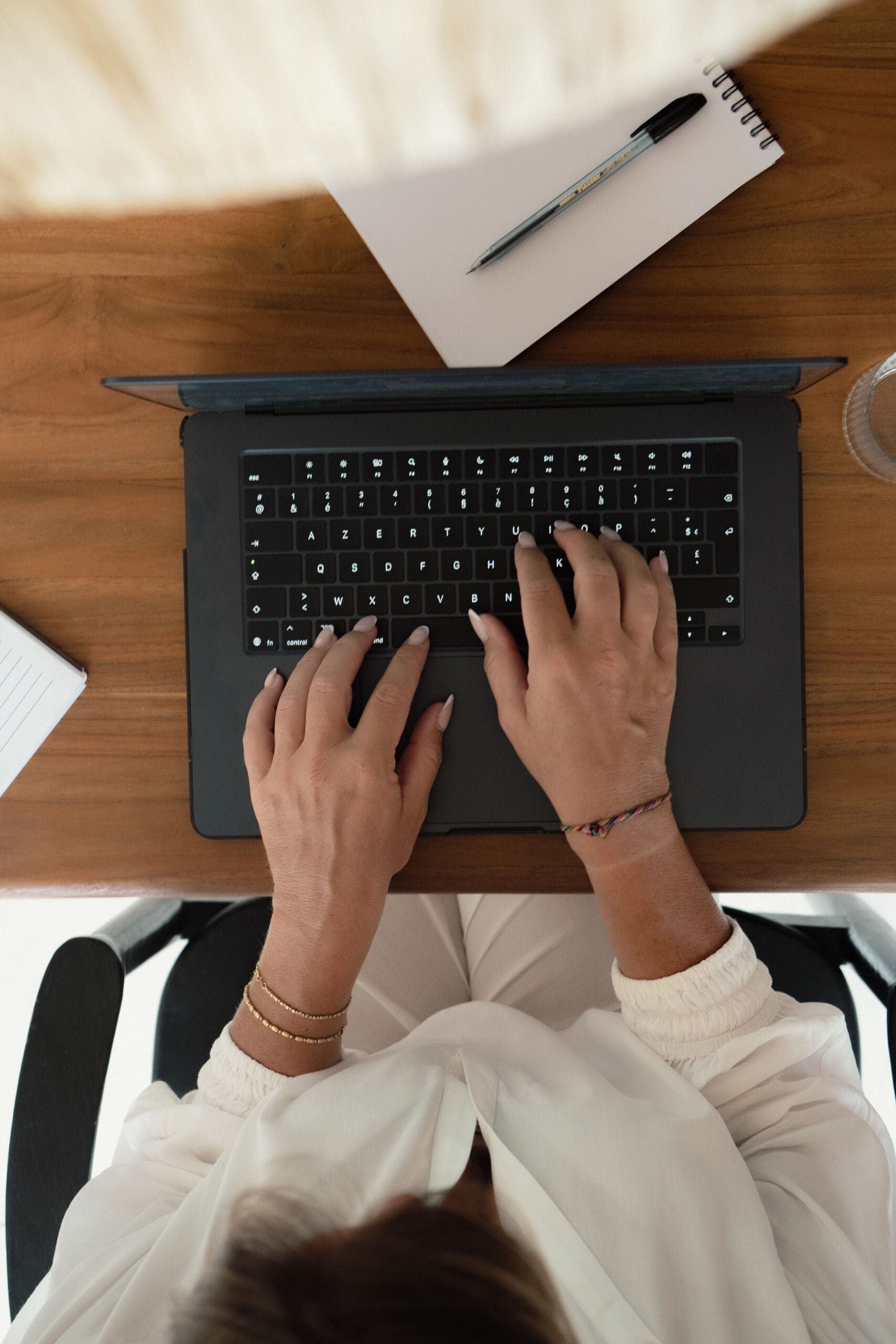 A woman typing on a laptop.