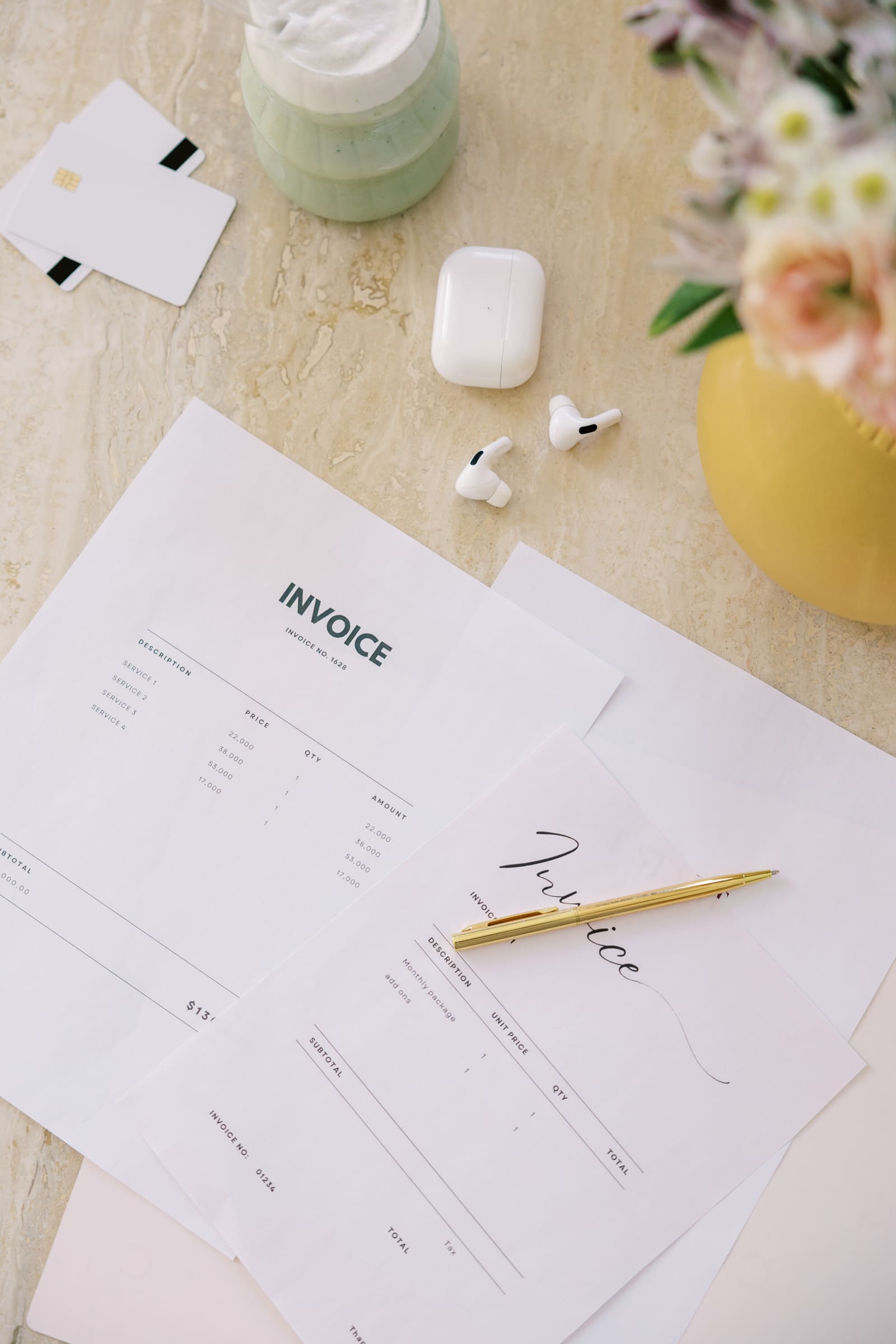 A desk with invoices scattered across.